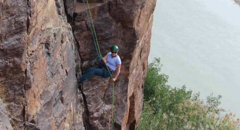 a person rappels down a rock walk in texas